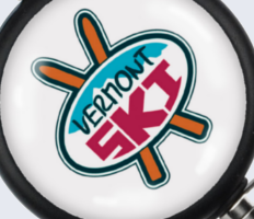 A close-up of Brady People ID custom dome label badge reels