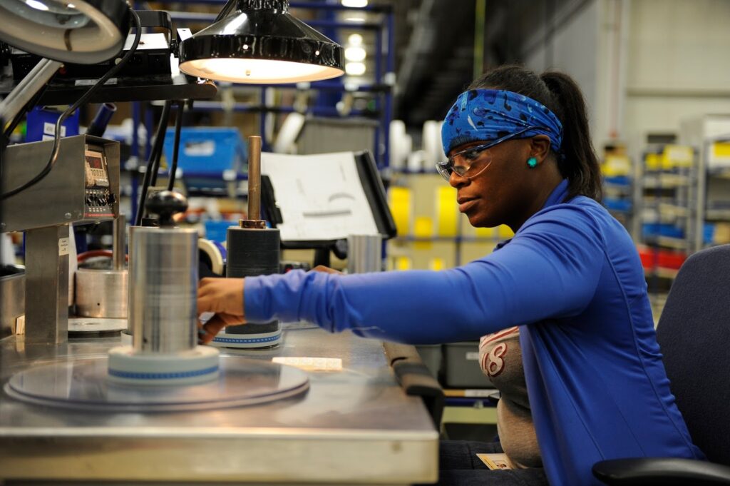 Brady manufacture working on products at desk